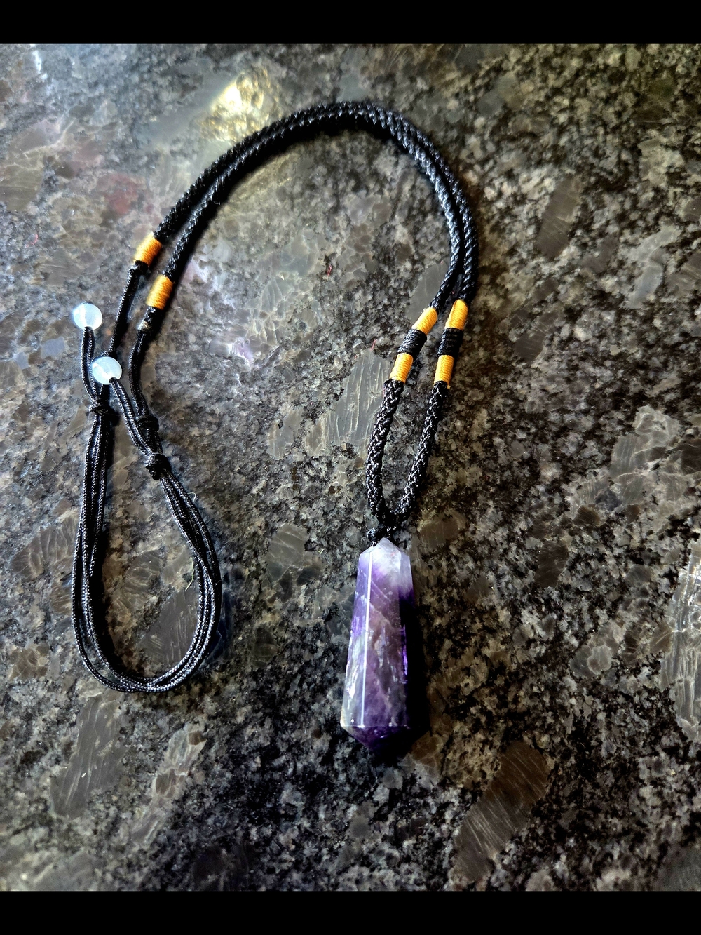 Black Cord Necklace with Purple Amethyst Point Pendant and Gold Tone Accent Wrap